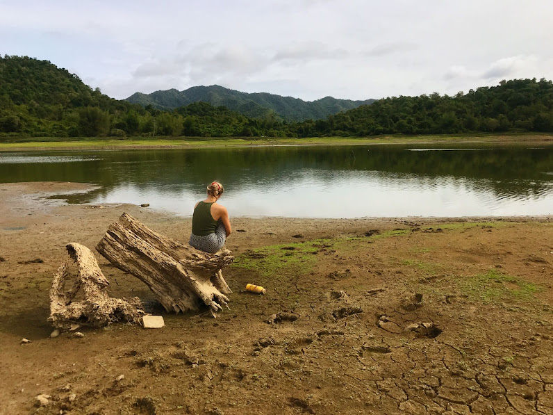 girl chilling by Yan Sue lake sitting on tree log