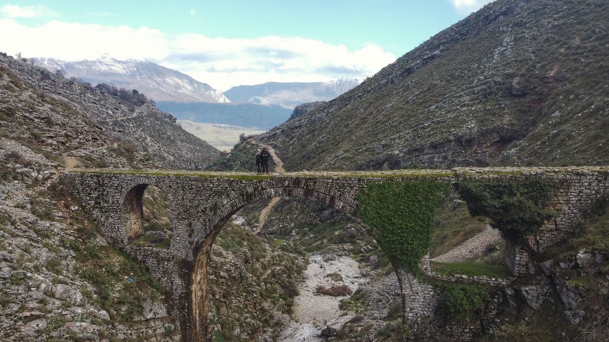 A drone picture of 2 people on Ali Pasha Bridge in Gjirokaster, Albania