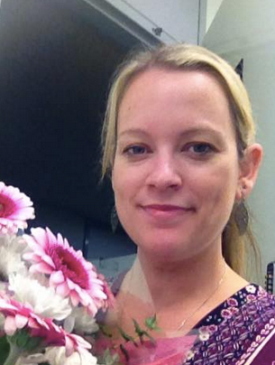 A picture of a woman with pink flowers