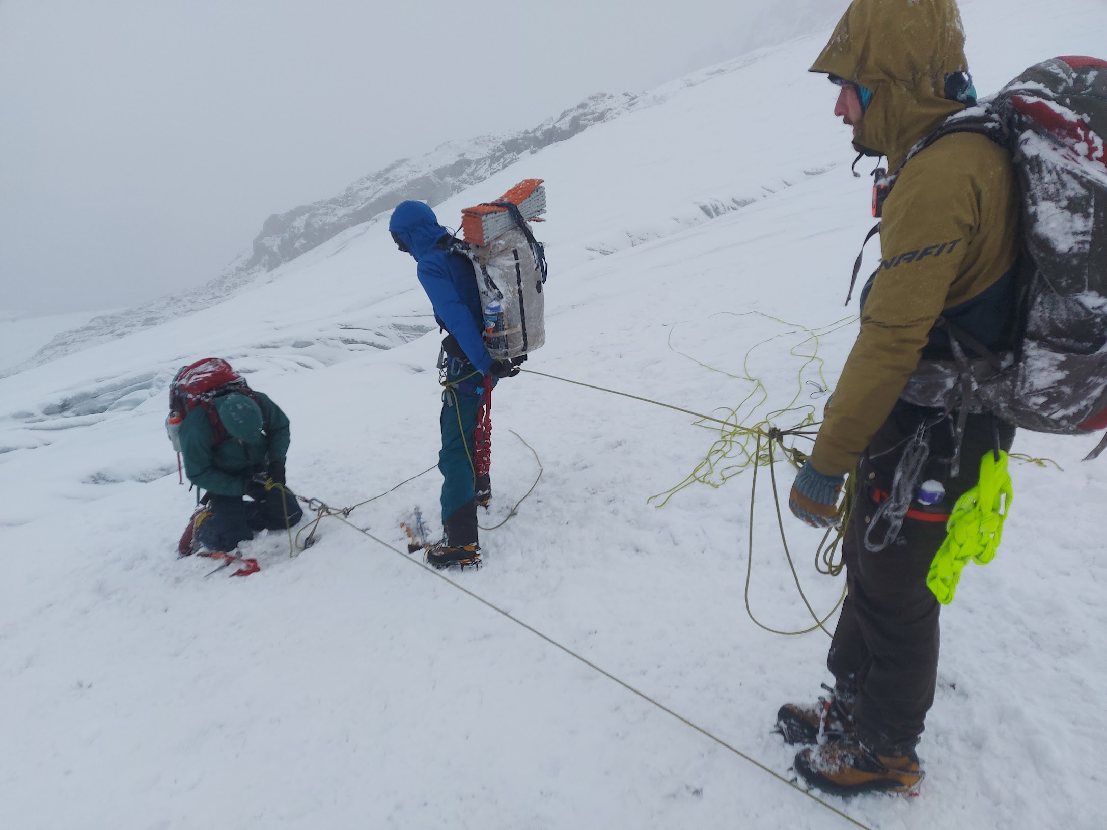 Three people working setting up a 3:1 rescue system