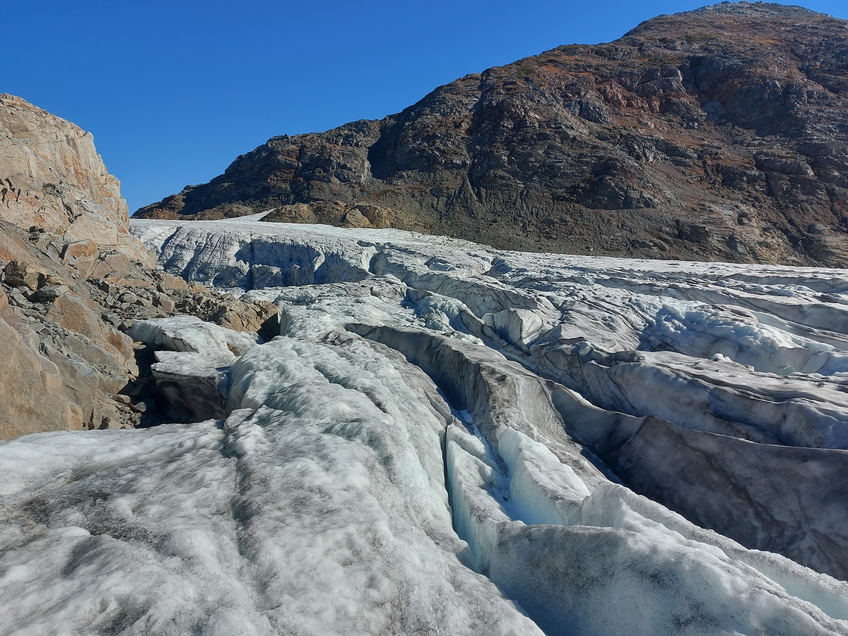 Crevassed glacier under blue sky