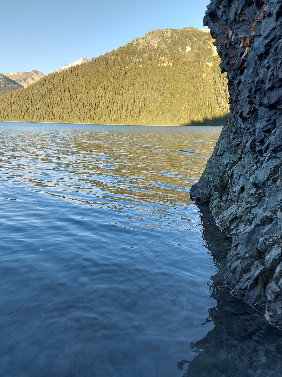 Cliff emerging from lake