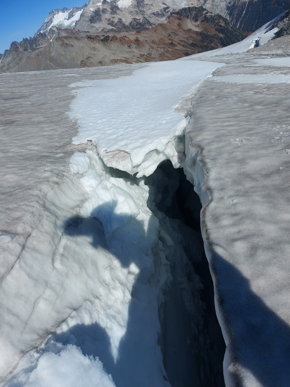 Crevasse that is open in the foreground but snow-bridged further back