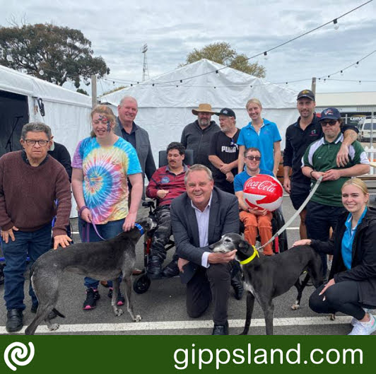 Tim Bull, pictured at the Sale Greyhound Racing Club with members of the local disability community, is encouraging eligible support groups to consider applying for funding for the disability self-help group