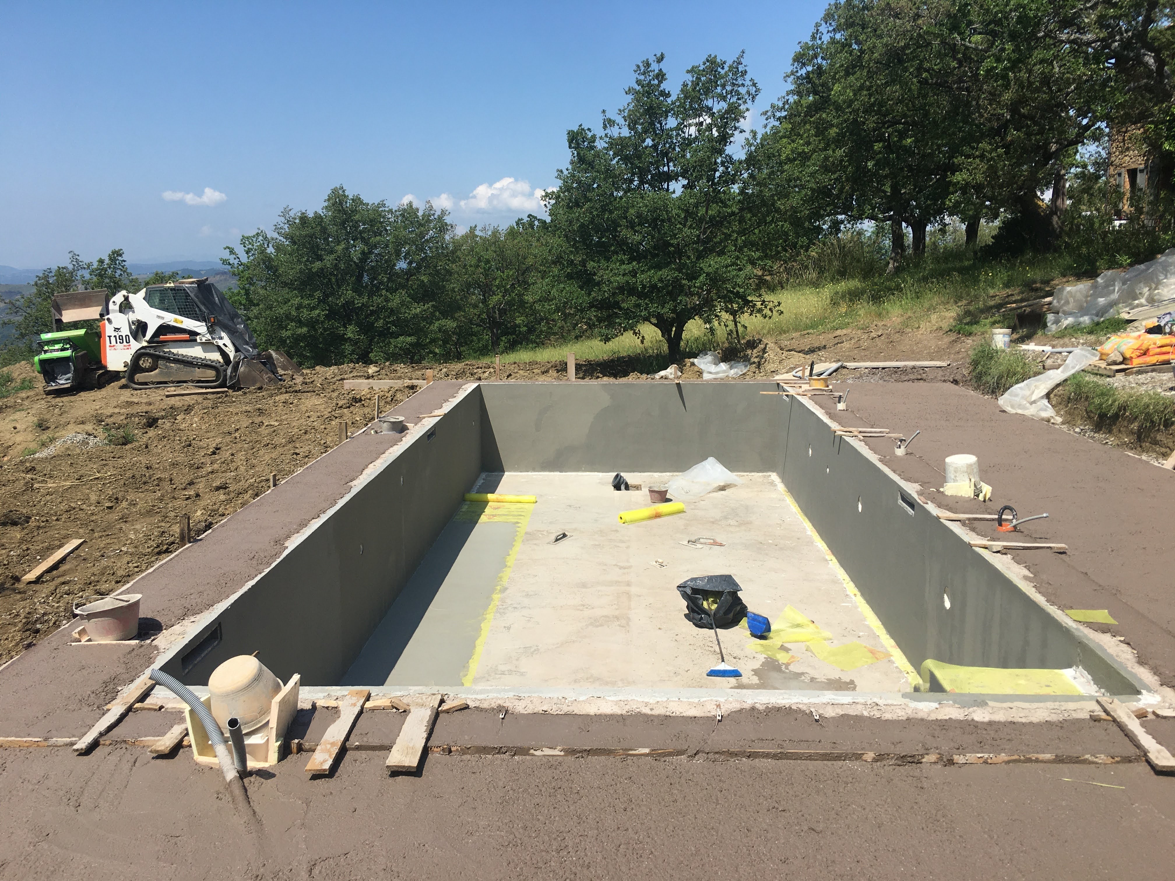 Constructing Santa Pia swimming pool, the final layer of concrete is finished