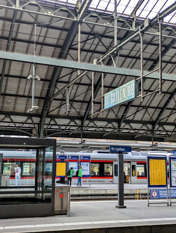 View from platforms of St. Gallen station. People waiting for a train