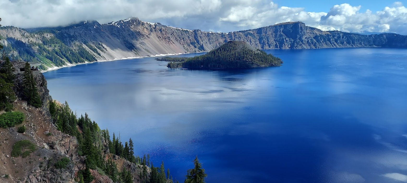 Views at Crater Lake National Park, view of Sinnott Memorial Observation Station, a stone shelter built 900 feet above Crater Lake on Victor Rock in 1930, from a spot on Rim Village Promenade