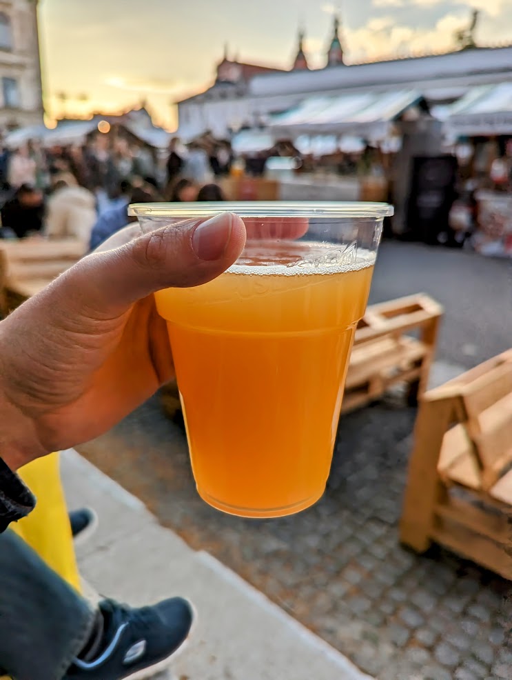 Light beer with sunset over market scene in background