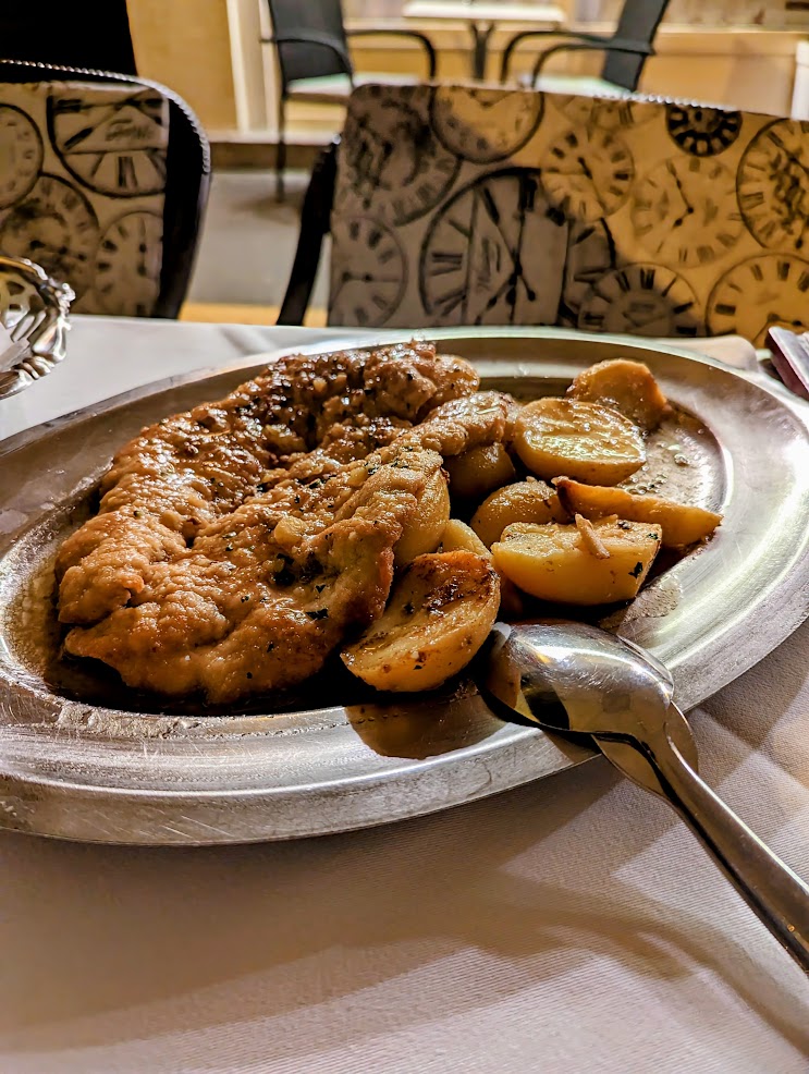 meat on a metal place with boiled potatoes