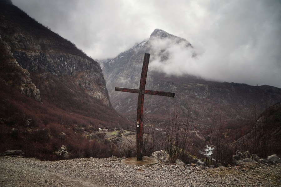 A wooden cross on the side of a main dirt road in Vukel, Shkoder County, Albania