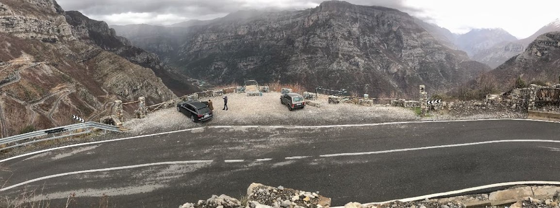 A panoramic picture of a view point in Rrapsh-Starja, Shkoder County, Albania. The view point looks over Tamara Gorge and Cemi River. Rocky mountains are everywhere.
