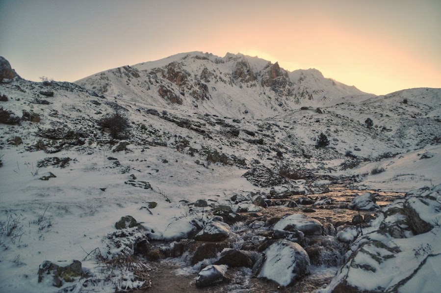 A stream of water flowing down on snowy Mount Korab, Diber County, Albania in the winter. 