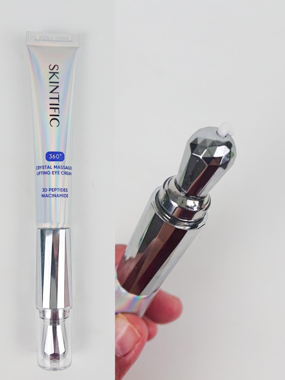 the shape of an eye cream applicator with a crystal massager and an activation metal area