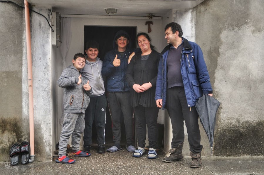 An Albanian family posing for a picture in front of their home in Vukel, Shkoder County, Albania