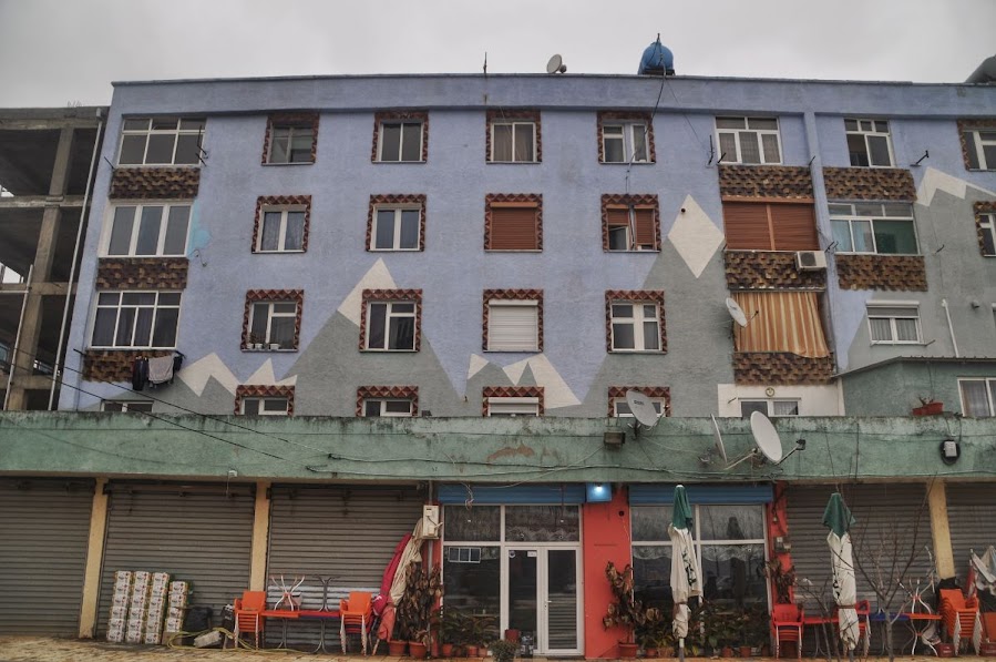 A blue residential building in Kukes, Albania