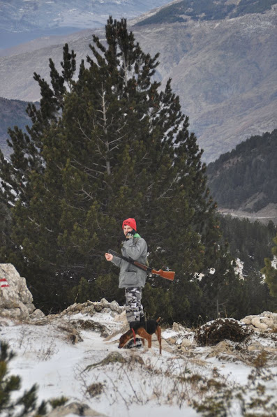 A hunter and his dog on snowy Mount Korab, Diber County, Albania in the winter
