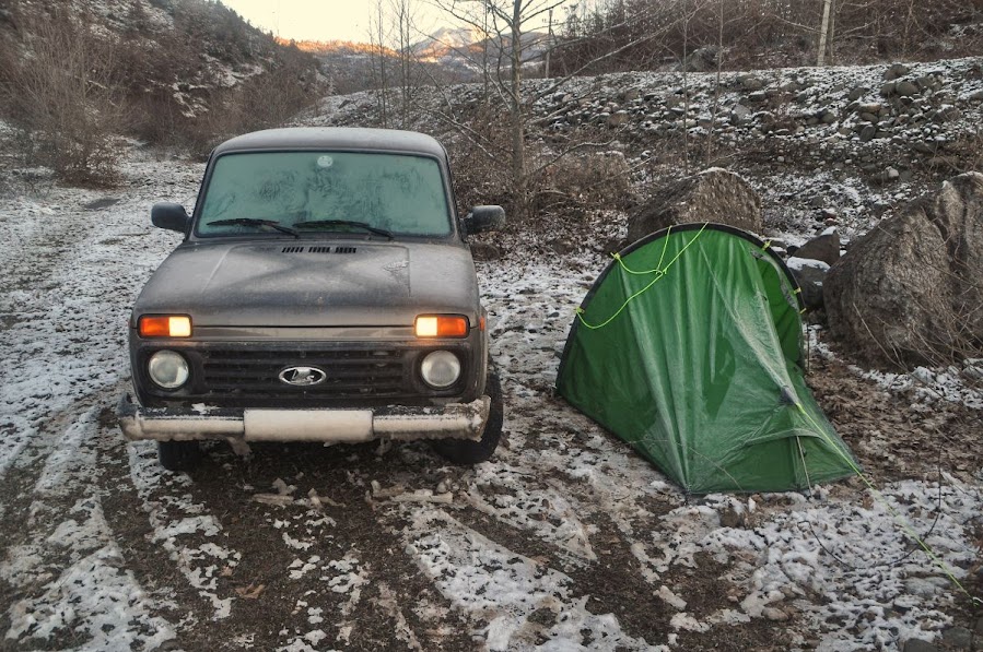 A car and camping tent parked on snowy land in Librazhd, Elbasan County, Albania in the winter