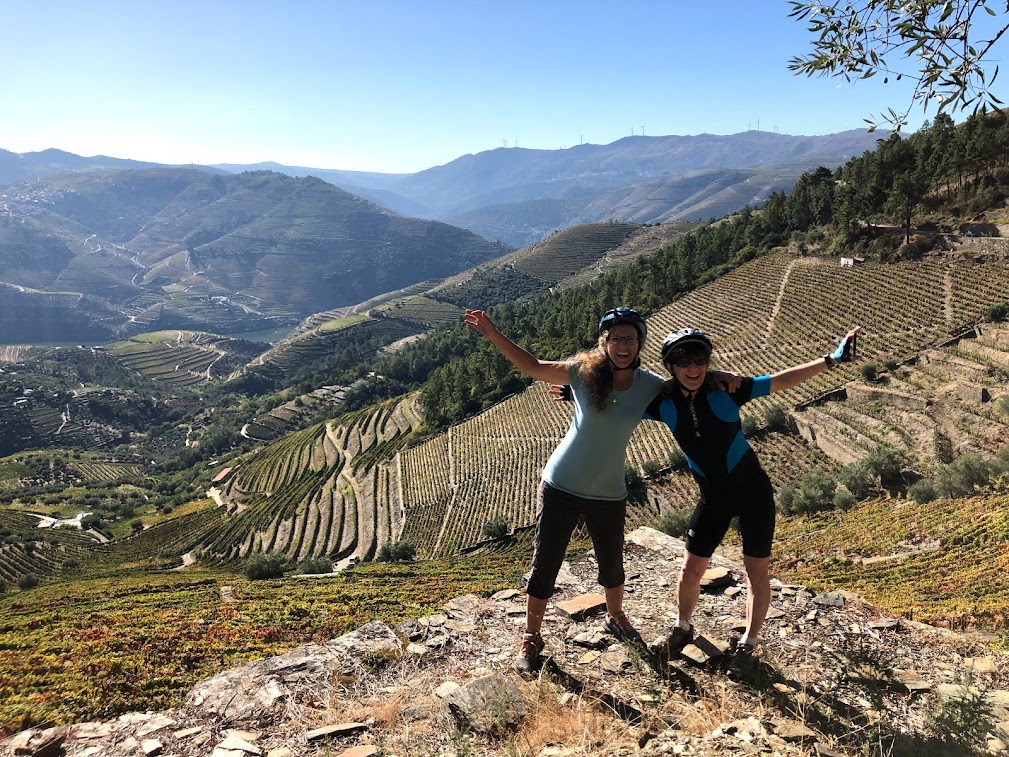 Two female cyclists pose overlooking the Douro Valley