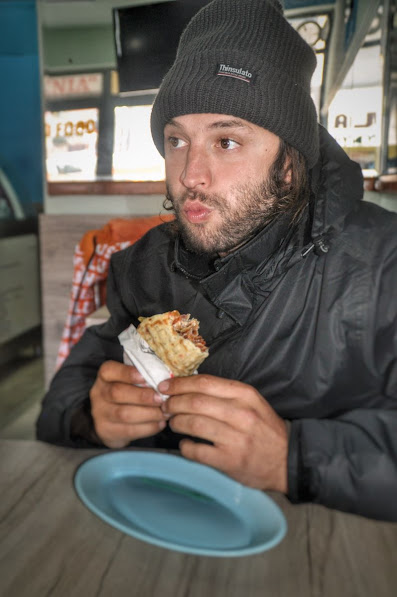 A man eating a gyros in the centre of Pogradec, Korce County, Albania