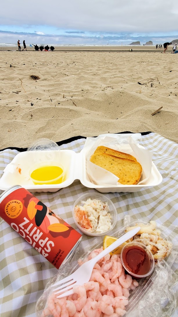 Enjoying shrimp and crab cocktail boat, and a small crab cocktail, with garlic bread and add on of melted butter from Ecola Seafood Market in Cannon Beach