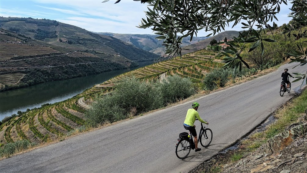 Couple cycling on ebikes in the Douro Valley in Portugal