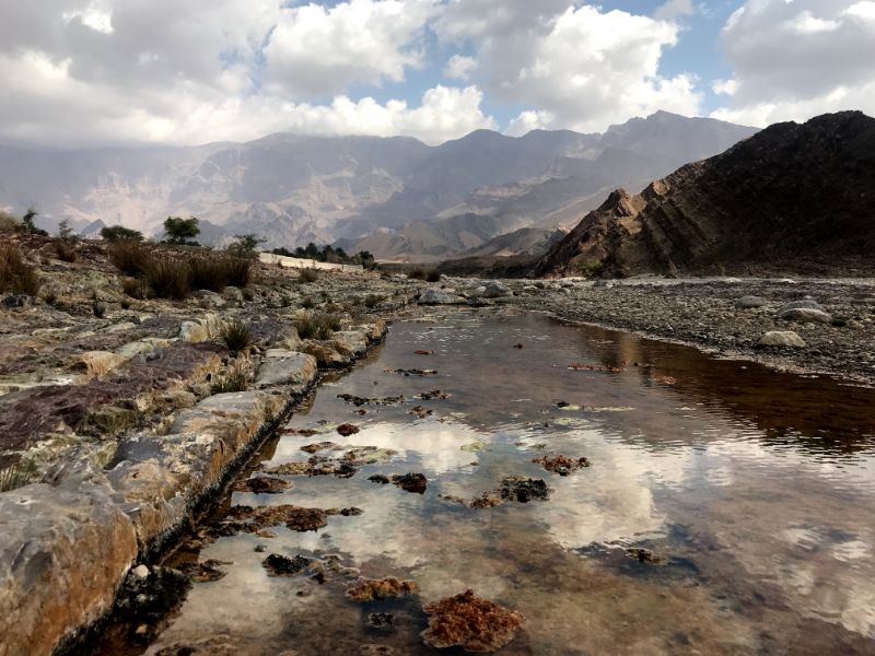 Water puddles at Wadi Bani Khalid bed oman road trip