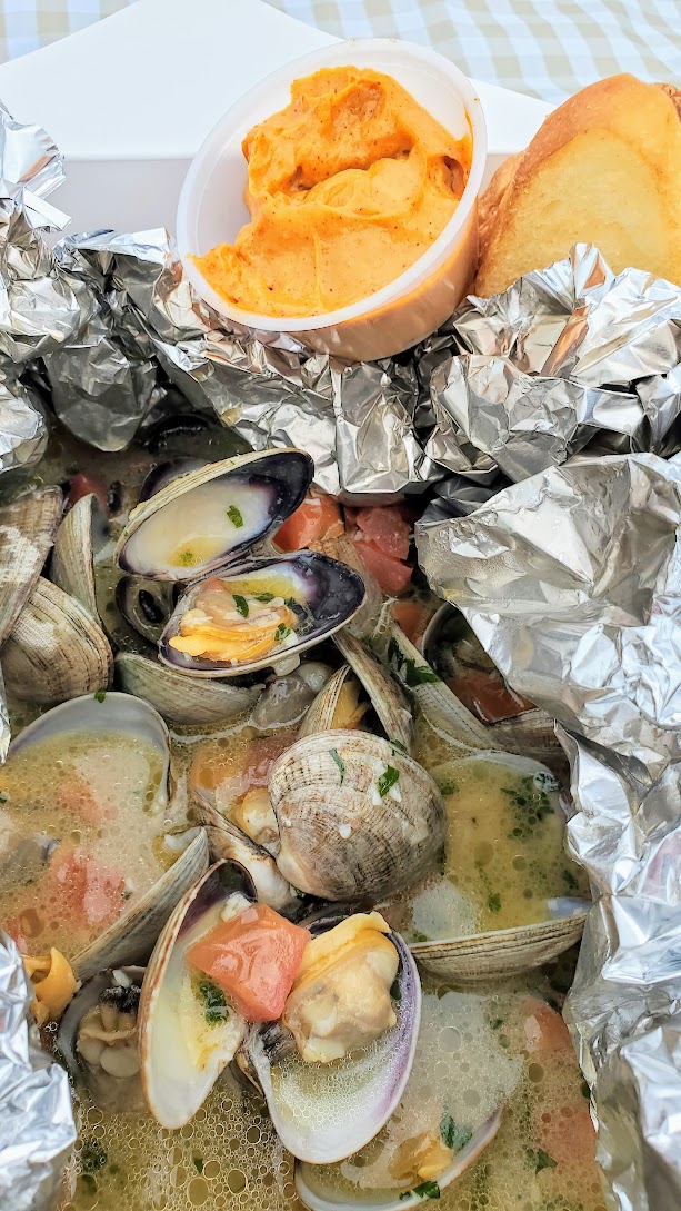 Takeout from Wayfarer Restaurant in Cannon Beach - Steamer Clams starring local Manila clams, Public Coast Brewing Co. ‘67 Blonde Ale, garlic, heirloom tomato, garden herbs, crostini, and smoked paprika aïoli