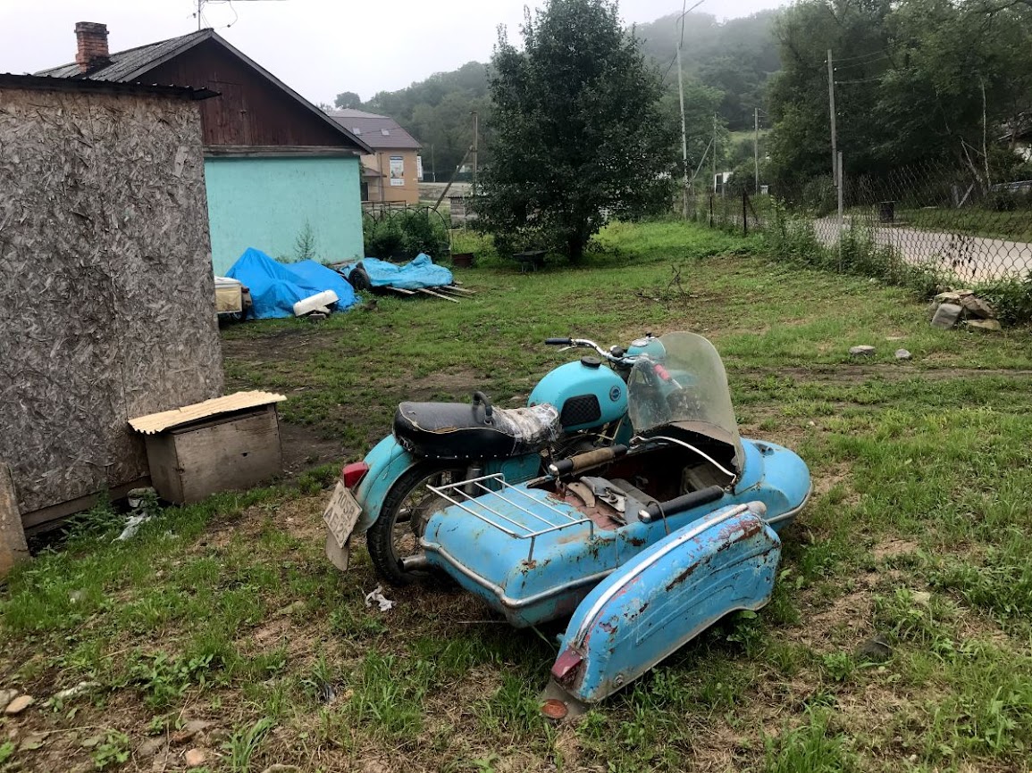 Superannuated motorbike in house yard in Bezverhovo primorky krai