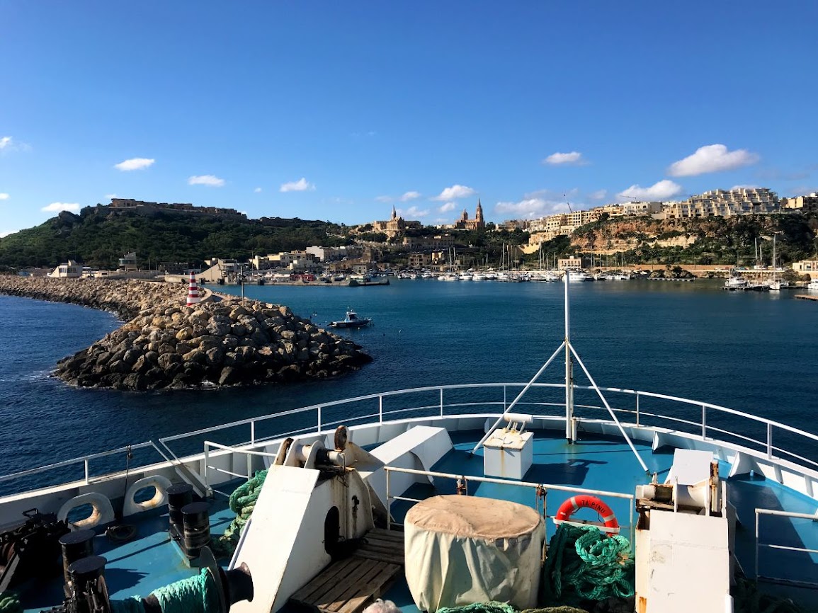 Boat entering Mgarr Port in Malta on a sunny day