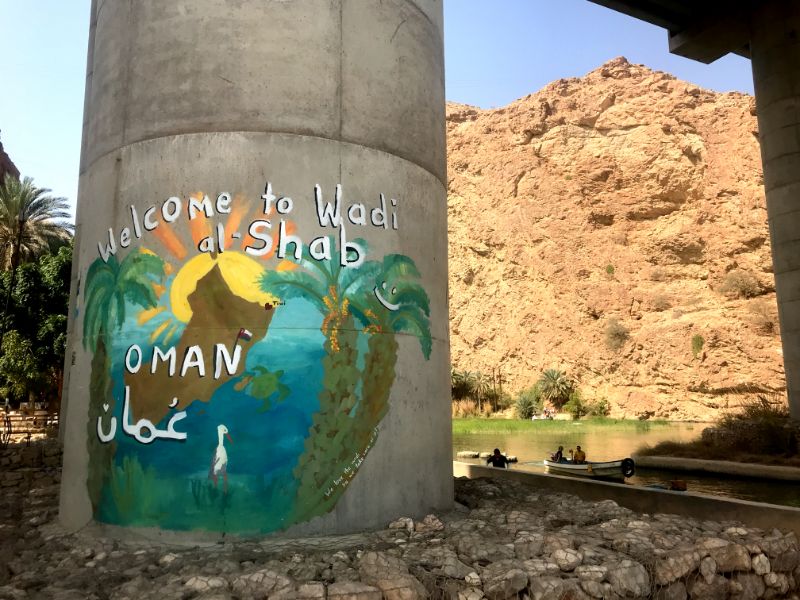 Welcoming mural to wadi shab oman on the bridge pillar