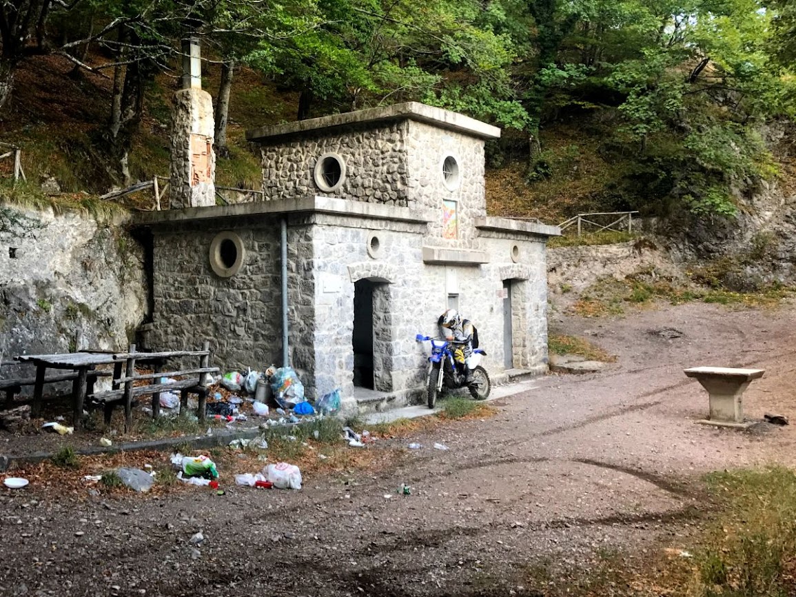 a yamaha wrf motorbike in front of stone hut by the foot of pizzo san michelle in the picentini mountains in italy 