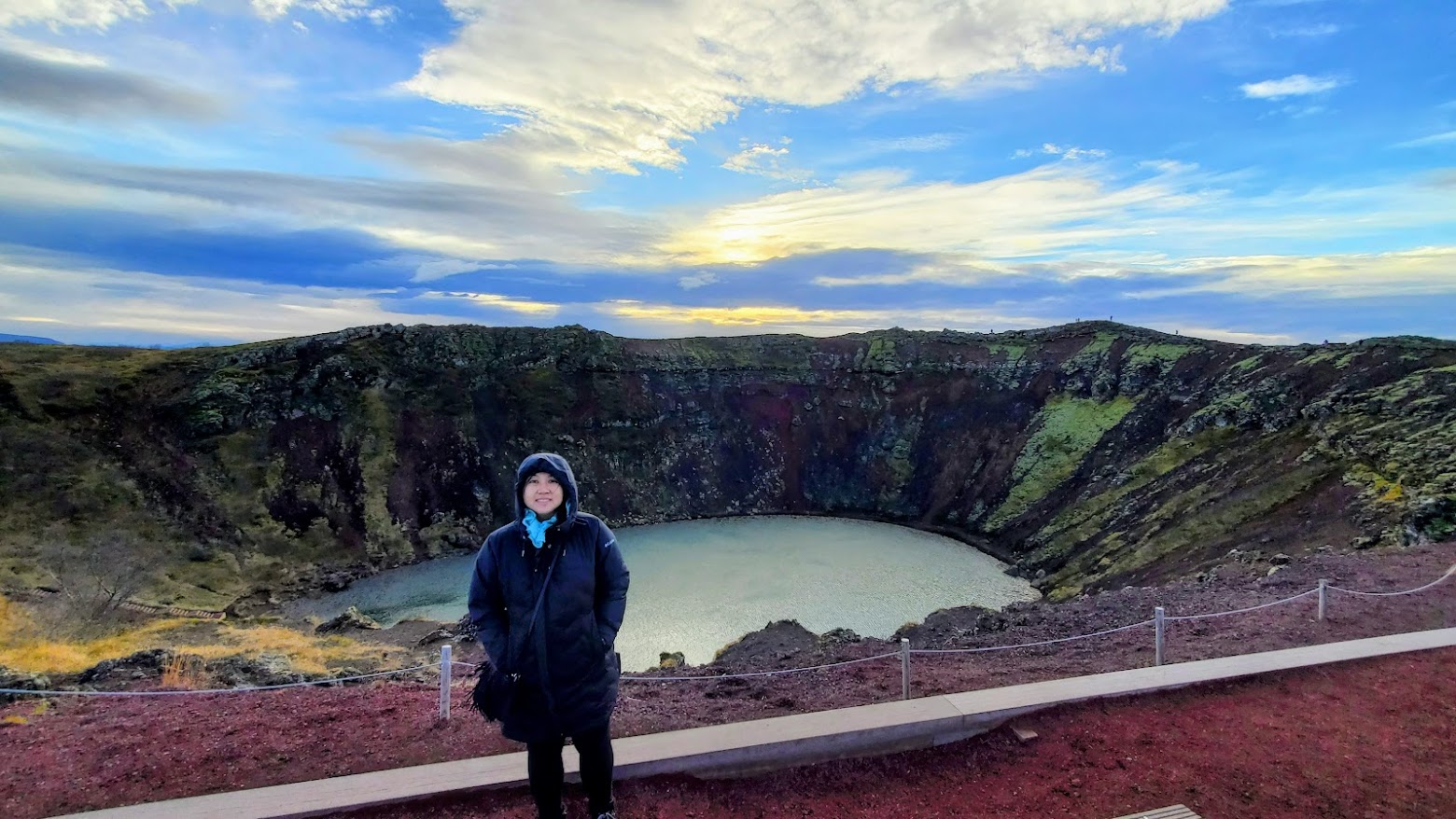 Golden Circle Highlights, Iceland: Kerið Crater is a volcanic crater lake with blue-green water amid stark red v and black volcanic rock and yellow grasses and green mosses