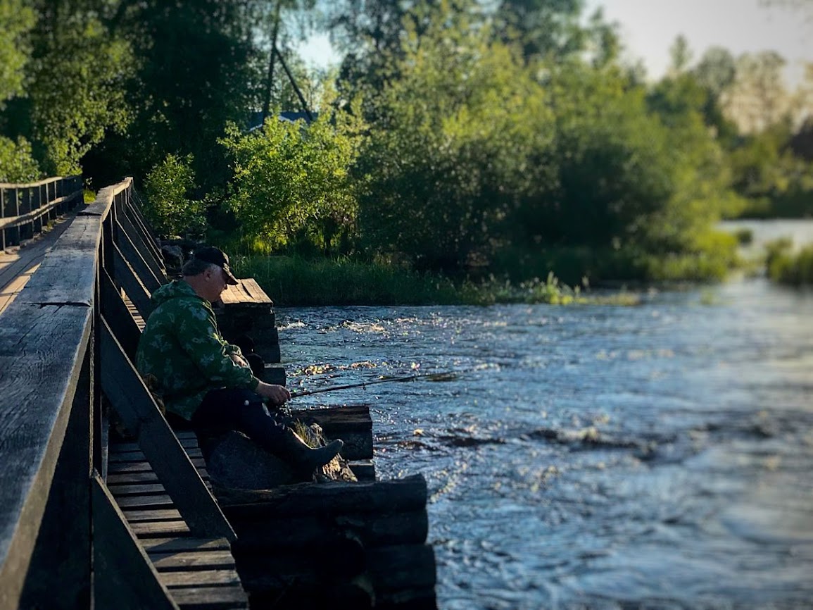 Russian villager fishing in the river near ladoga lake 