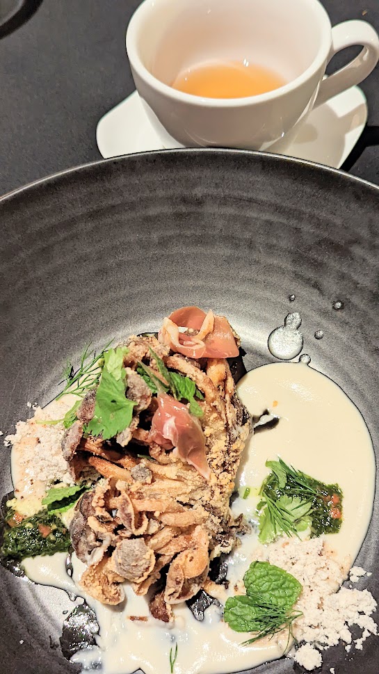 Urban Farmer Mushroom Dinner, Hon shimeji mushroom conserva, coconut and cashew broth, crispy chanterelles, apple, duck prosciutto served with a white matsutake tea by Chef Ryan Rau of Urban Farmer Denver