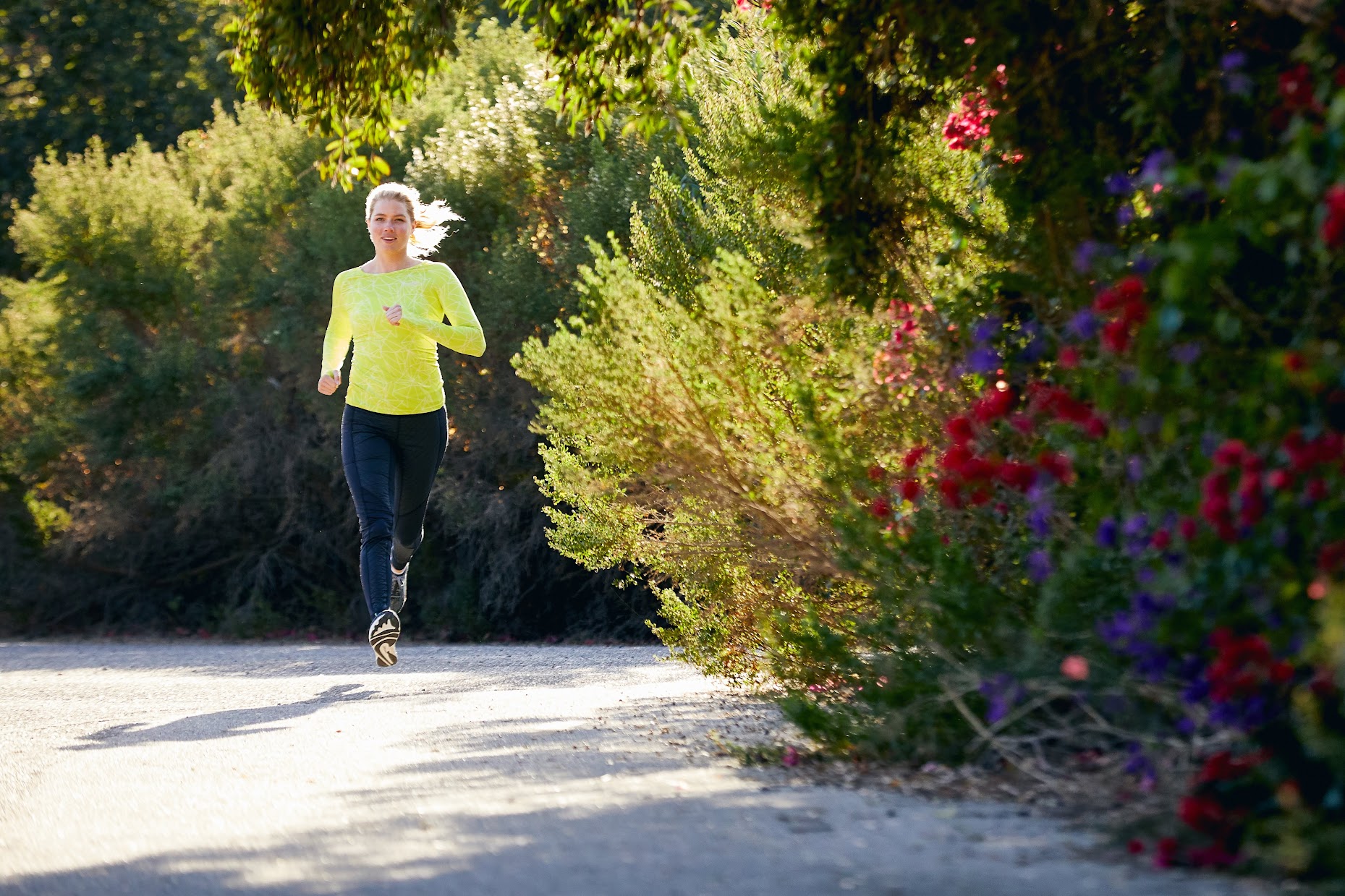 Runner in the sun on trail