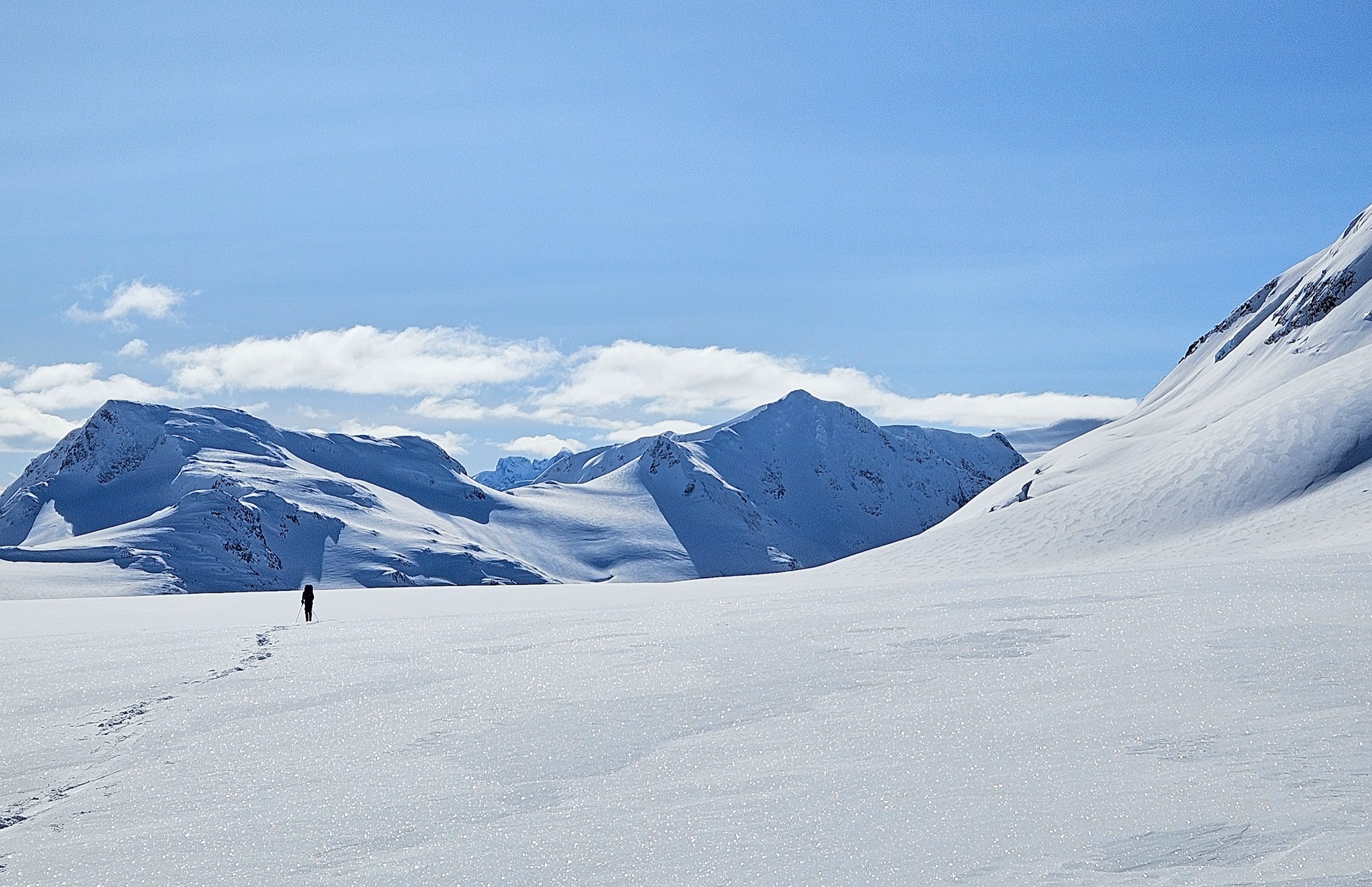 Skier heading towards distant mountains