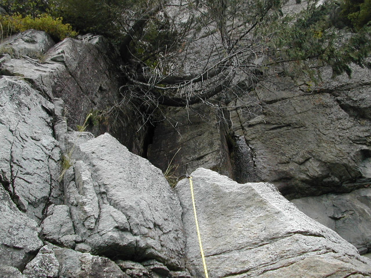 Looking up at a grappling hook on a ledge