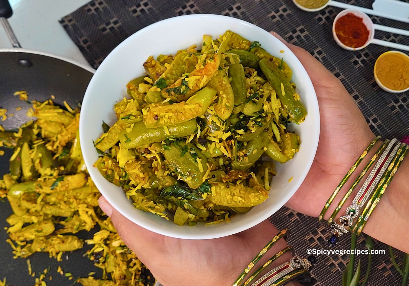 Delicious Tendli Ki Sabji served in a bowl, garnished with fresh coriander leaves, alongside roti and a side of yogurt