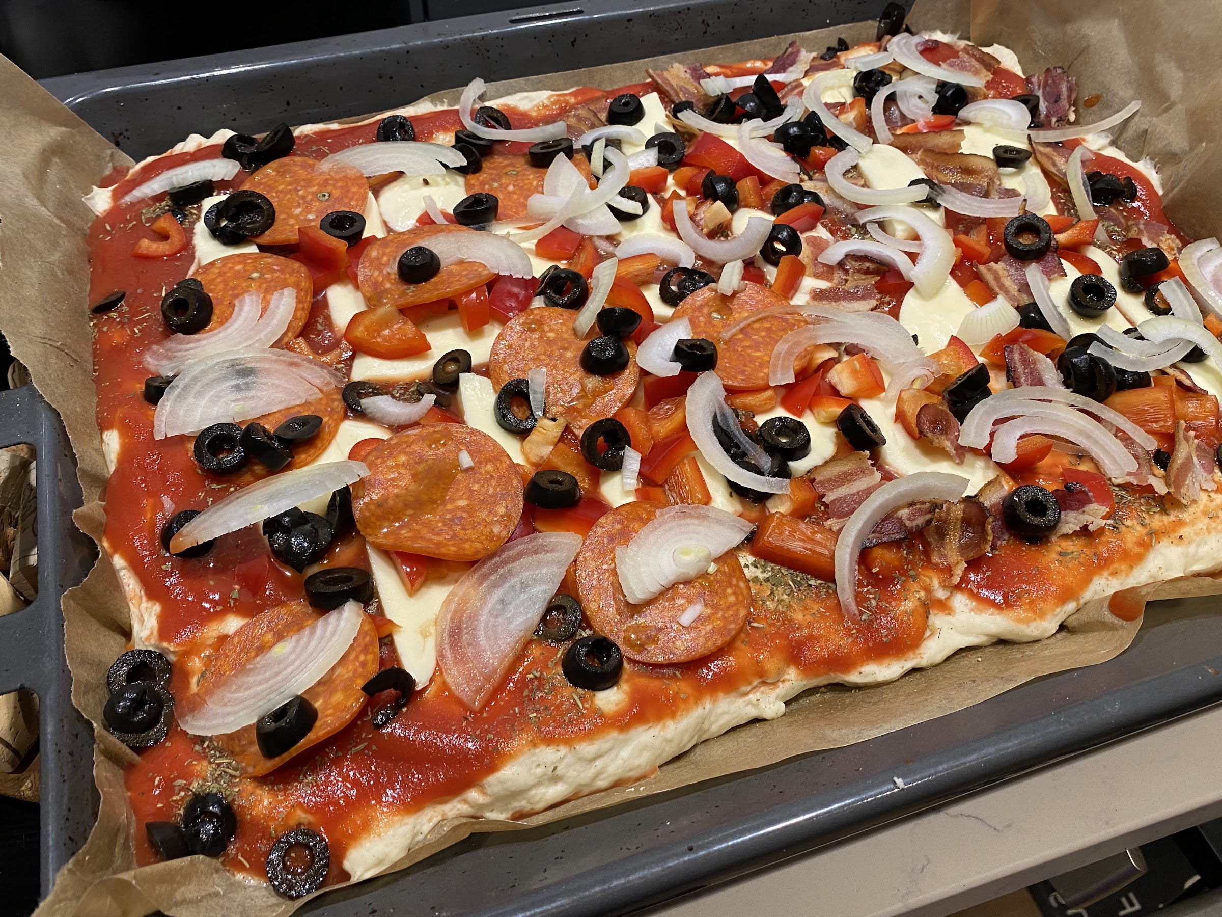 Spread toppings on the pizza base