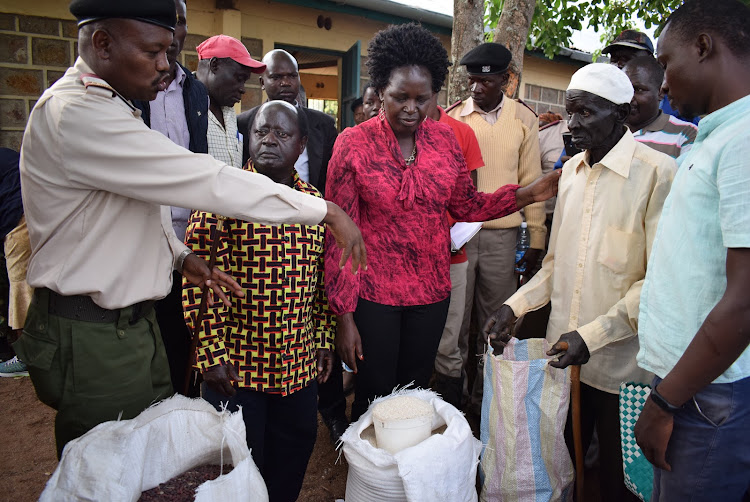 Homa Bay county commissioner Kipkemei Yetich, MPs Adipo Okuome (Karachuonyo) and Lillian Gogo (Rangwe) give relief food to flood evicted persons in Kibiri, Karachuonyo constituency on December 28,2019