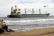 RACE AGAINST TIME: Attempts are being made to salvage and refloat bulk carrier Kiani Satu, which was driven aground at Buffels Bay near Knysna in the Western Cape on Thursday last week Picture: EWALD STANDER