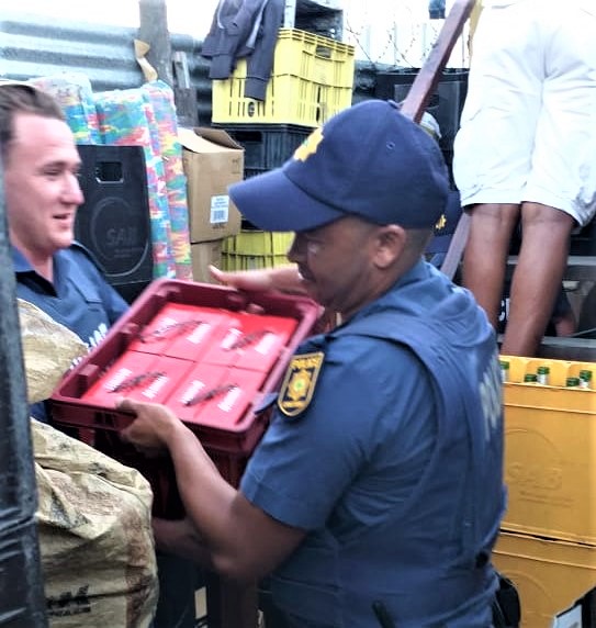 Police confiscate liquor during the raid across Walmer township on Tuesday