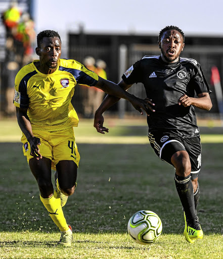 Ajax Cape Town's Raymond Monama, right, fights for the ball with Jomo Cosmos' Tebogo Mabula during their National First Division season-opening match last weekend. Monama wants to help Ajax to make a quick return to the Premiership.