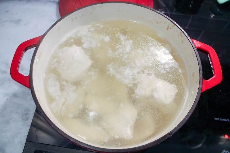 Chicken Boiling In A Dutch Oven.