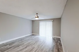 Living room with ceiling fan and wood inspired flooring