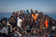 Refugees and migrants wait to be rescued near Lampedusa, Italy. Many migrants attempt the dangerous central Mediterranean crossing from Libya to Italy. File photo. 