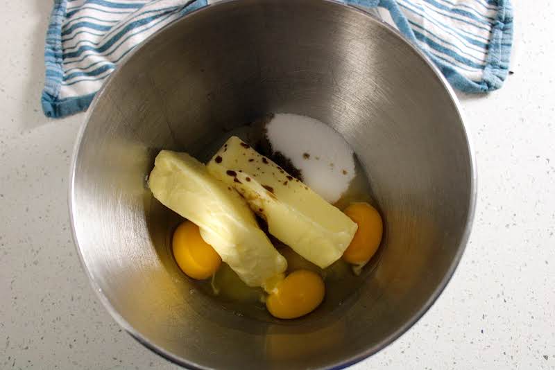 Butter, Sugar, Eggs, And Vanilla In A Bowl.