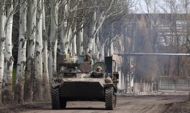 An armoured military vehicle speeds through Chasiv Yar during heavy fighting at the front line of Bakhmut and Chasiv Yar, Ukraine, April 9 2023. Picture: KAI PFAFFENBACH/REUTERS