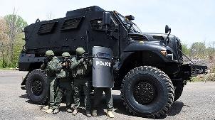 A group of soldiers standing next to a military vehicle

Description automatically generated with medium confidence