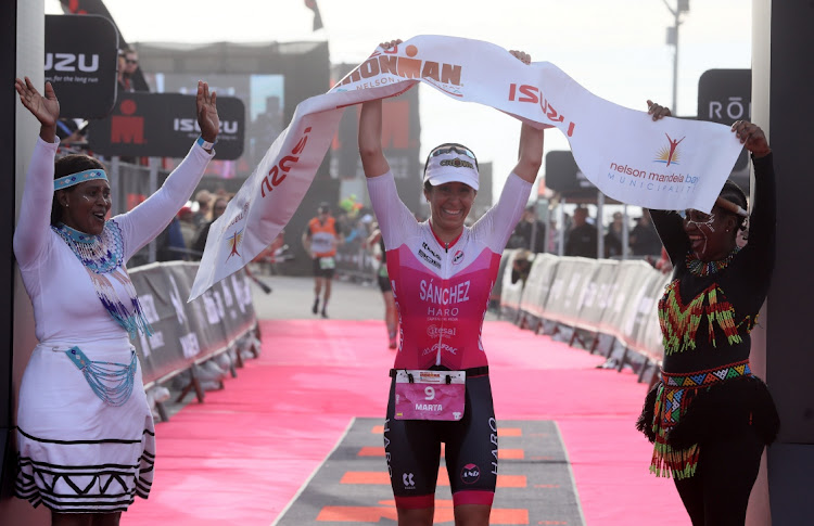 Isuzu Ironman Nelson Mandela African Championships women’s winner Marta Sanchez crosses the finish line at Hobie Beach in Gqeberha.